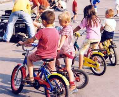 a bunch of kids riding bicycles